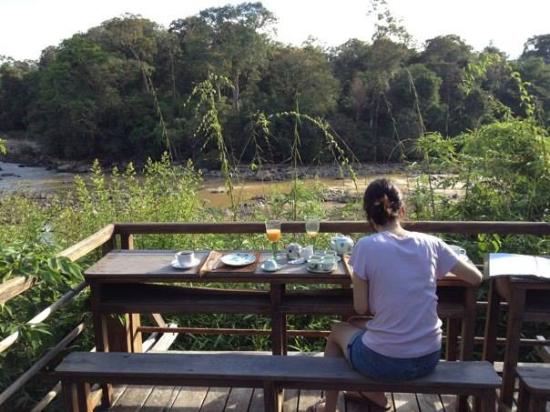 Tourist enjoys the breakfast by the river